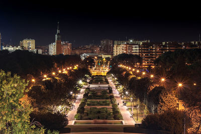 High angle view of illuminated buildings against sky at night