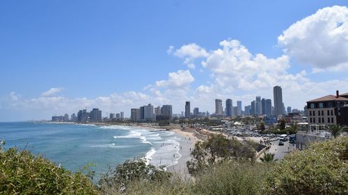 Panoramic view of sea and buildings against sky