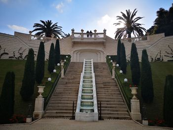 Low angle view of steps amidst buildings against sky