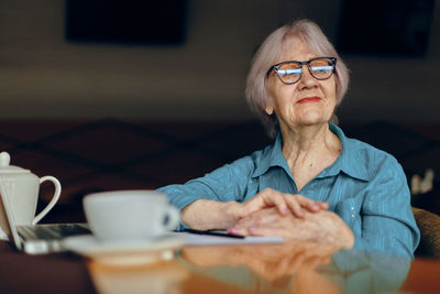Senior woman having coffe at home