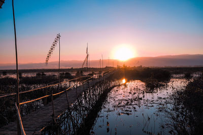 Scenic view of river against sky during sunset