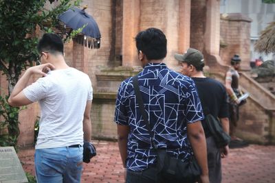 Rear view of people walking in temple