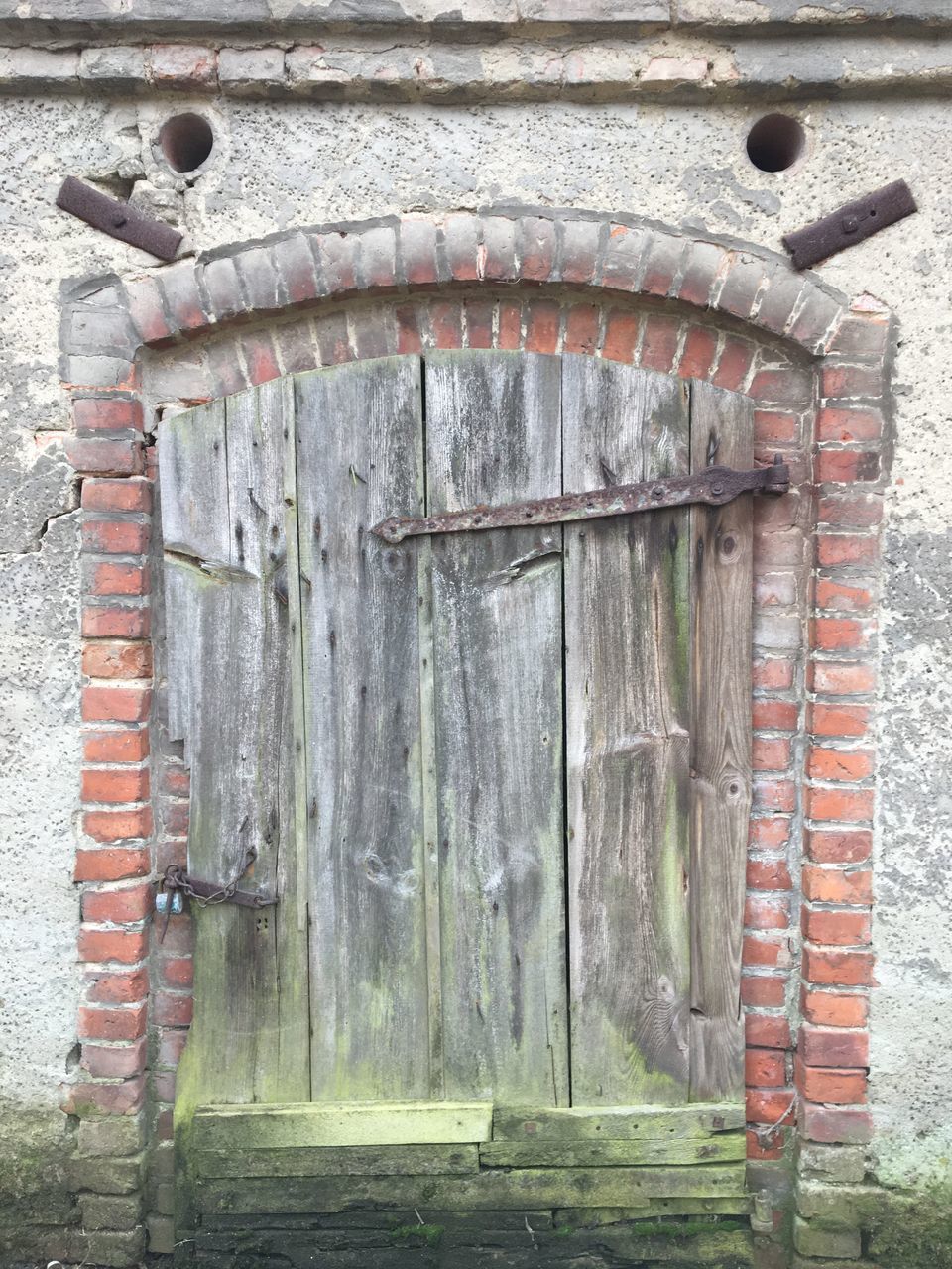 OLD WEATHERED WALL WITH DOOR