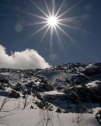 Scenic view of snow covered mountains against sky