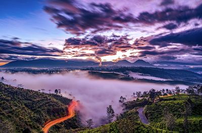 Scenic view of land against sky during sunrise