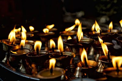 Lit tea light candles in temple