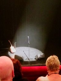 Rear view of friends looking at camera