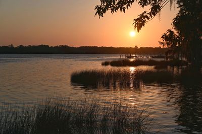 Scenic view of lake against orange sky