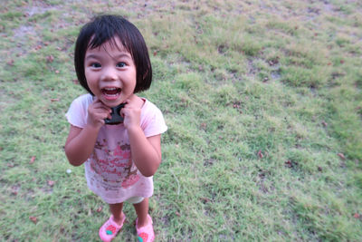 Portrait of cute girl standing on field