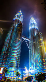 Low angle view of illuminated skyscraper against sky at night