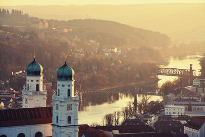 St stephen cathedral by inn river in passau during sunset