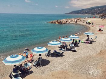 High angle view of people relaxing at beach