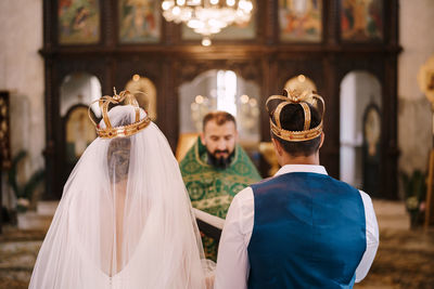 Rear view of couple kissing in temple