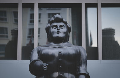 Statue by window of building