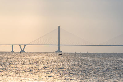 View of suspension bridge over sea