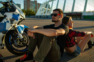 Low angle view of man riding motorcycle on street