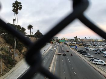 Cars on road in city against sky