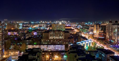 Aerial view of city lit up at night