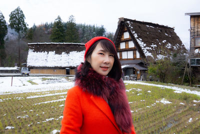 Portrait of beautiful woman standing in snow