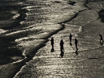 High angle view of silhouette people at brighton beach during sunset