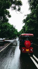 Red car on street in rainy season