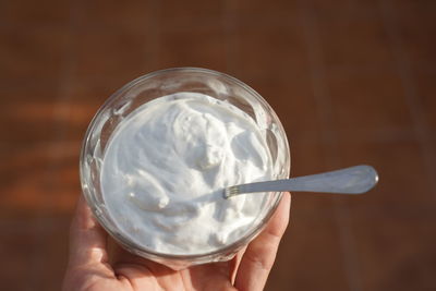 Close-up of hand holding ice cream