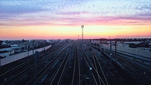 High angle view of railroad tracks against sky during sunset