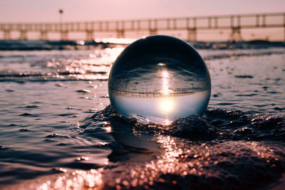 Close-up of crystal ball on beach