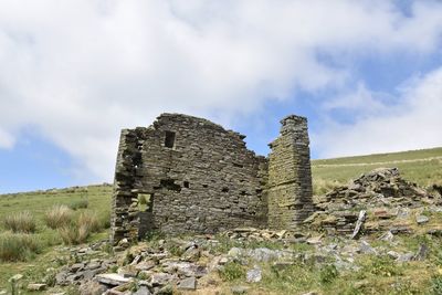 Old ruin building against cloudy sky