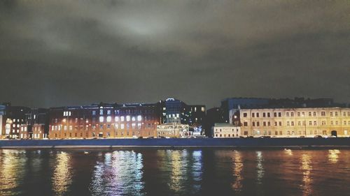 Reflection of illuminated buildings in water at night