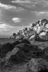 Rocks on beach against sky