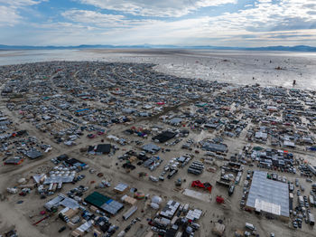 High angle view of townscape by sea against sky