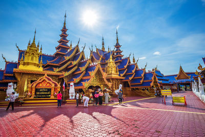 Group of people outside temple against building