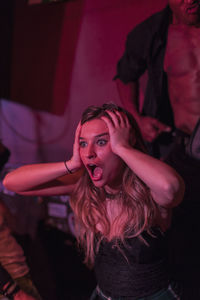 Young woman having fun at a night club