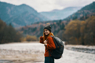 Young woman standing on snow covered mountain