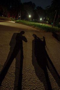 Shadow of people on street at night