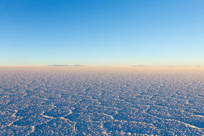 Scenic view of landscape against clear blue sky