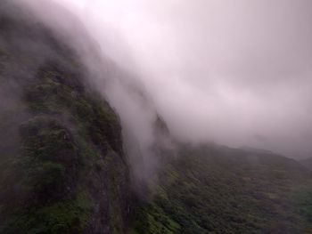 Scenic view of fog covered mountains