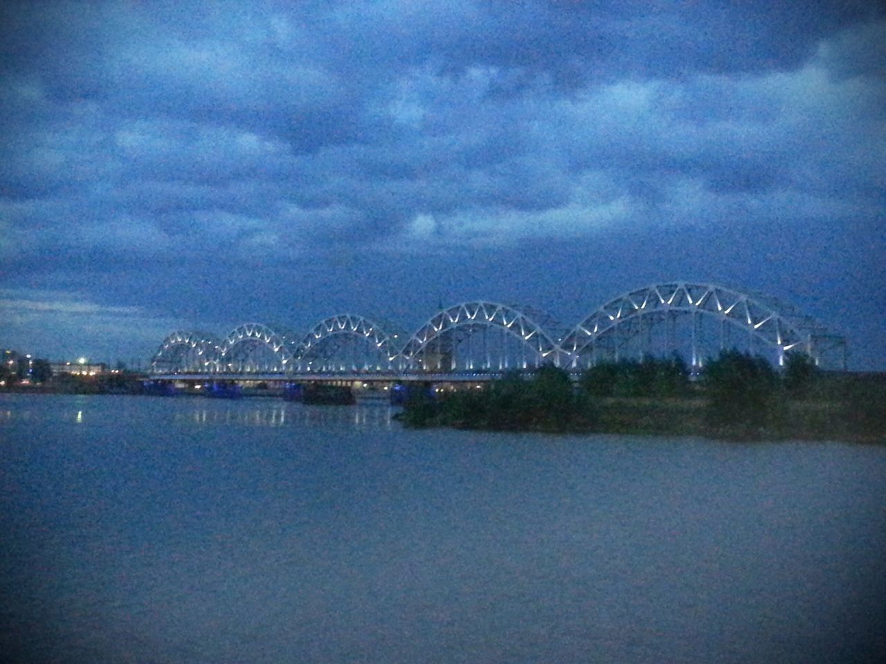 sky, water, illuminated, night, connection, cloud - sky, waterfront, built structure, architecture, bridge - man made structure, river, dusk, reflection, sea, cloudy, scenics, tranquil scene, tranquility, cloud, nature