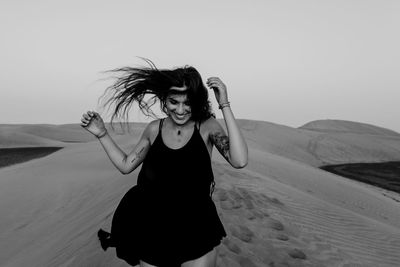 Young woman standing in a desert