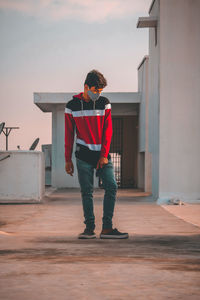 Full length of man standing outdoors against sky