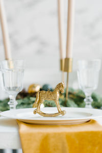 Gold figurine of a vintage horse in the design of a festive serving of a christmas dinner or lunch