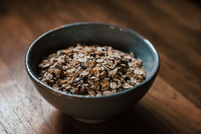 Flakes in blue bowl on wooden table