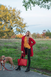 Woman with dog on field during autumn