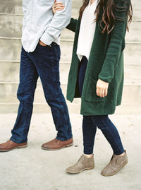 Low section of friends standing outdoors
