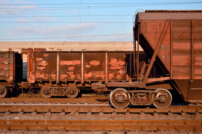 Trains at railroad tracks against sky