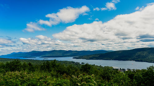 Scenic view of lake and mountains against sky