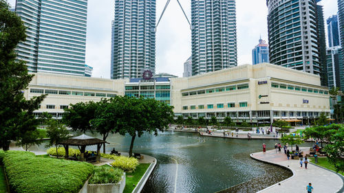 Buildings by river in city