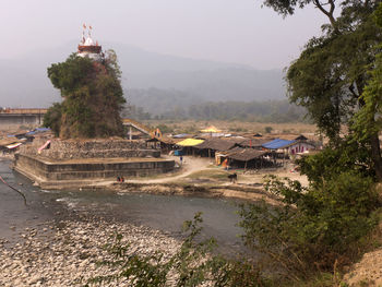 Scenic view of historic building by mountains against sky