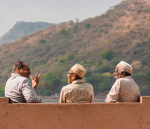 Rear view of people , three friends spending time with each other share their experiences of life 